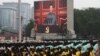 FILE - Chinese President Xi Jinping is seen on a giant screen as he delivers a speech at the event marking the 100th founding anniversary of the Communist Party of China, on Tiananmen Square in Beijing, China, July 1, 2021. 