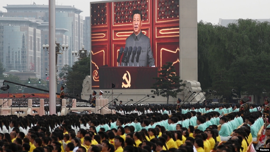 FILE - Chinese President Xi Jinping is seen on a giant screen as he delivers a speech at the event marking the 100th founding anniversary of the Communist Party of China, on Tiananmen Square in Beijing, China, July 1, 2021. 