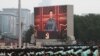 FILE - Chinese President Xi Jinping is seen on a giant screen as he delivers a speech at the event marking the 100th founding anniversary of the Communist Party of China, on Tiananmen Square in Beijing, July 1, 2021. 