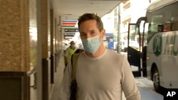 Australian Broadcasting Corp. journalist Bill Birtles walks into a hotel for quarantine in Sydney, Australia, Sept. 8, 2020. 