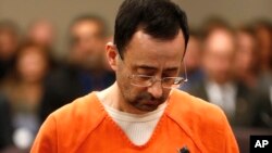 FILE - Dr. Larry Nassar, 54, appears in court for a plea hearing in Lansing, Michigan, Nov. 22, 2017. Nassar has pleaded guilty to molesting female gymnasts.