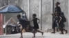 A woman and three children flee their home from gang violence in Port-au-Prince, Haiti, on Oct. 20, 2024.