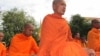 The monks were stopped by security forces, who had blocked the roads surrounding the palace. The monks then sat in front of the barricades, meditating for hours, into evening. 