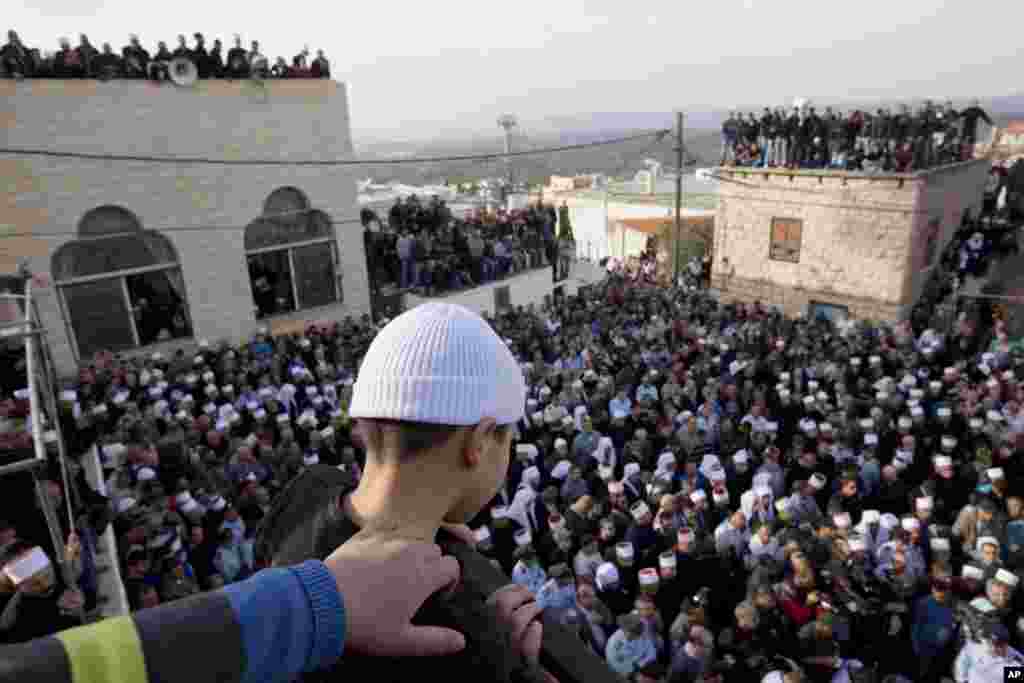 Druze men and relatives attend the funeral of Druze Israeli police officer Zidan Sif in the Druze village of Yanuh-Jat, northern Israel. Sif, 30, died of his wounds on Tuesday after Two Palestinian cousins armed with meat cleavers and a gun stormed a Jerusalem synagogue during morning prayers Tuesday, killing four people in the city’s bloodiest attack in years.