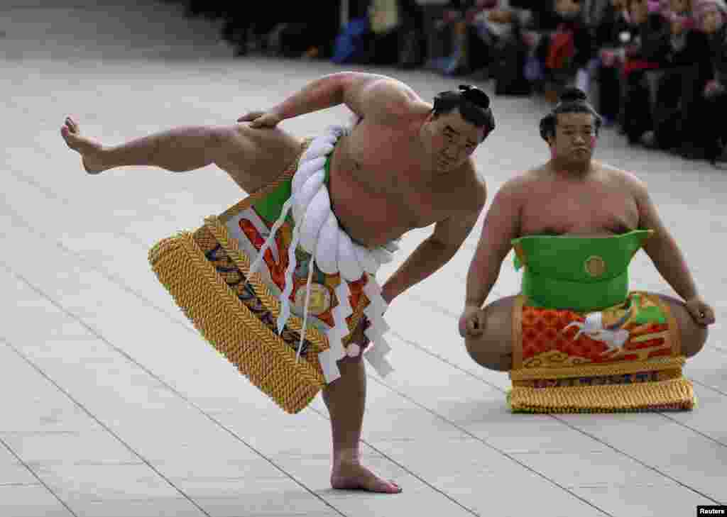 Mongolian-born grand sumo champion Yokozuna Harumafuji (L) performs the New Year&#39;s ring-entering rite at the annual celebration for the New Year at Meiji Shrine in Tokyo, Japan.