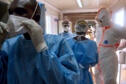 Medical staff of International Medical Corps put on Personal Protective Equipment at the isolation ward of Ministry of Health Infectious Disease Unit in Juba, South Sudan, on April 24, 2020.
