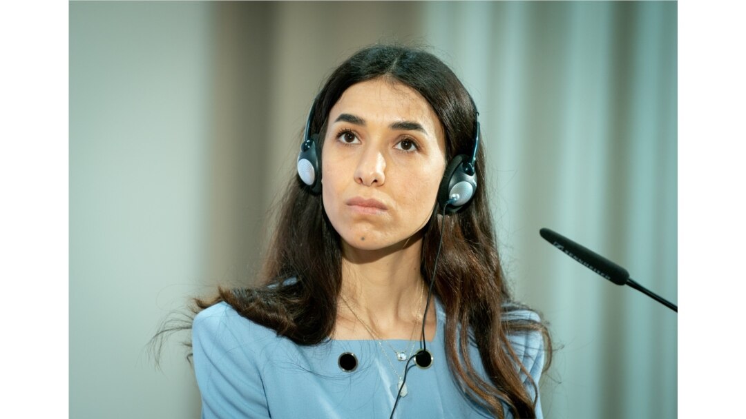 FILE - Nobel Peace Prize laureate and Yazidi activist Nadia Murad listens during a symbolical start of the lectures "Women, Peace and Security" in Berlin, Germany, May 7, 2021.