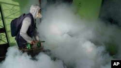 Un trabajador de la salud fumiga mosquitos dentro de una casa para ayudar a mitigar la propagación del dengue en el área de Las Peñitas de Talara, Perú, el 1 de marzo de 2024.