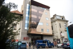 Police cars are parked outside the Duke Hotel where Gholamreza Mansouri died after falling from a high floor inside a hotel, in Bucharest, Romania, June 19, 2020.