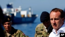 Denmark’s Foreign Minister Martin Lidegaard (r) speaks to the Danish sailors aboard the Danish warship "Esbern Snare" which is escorting the cargo ships that are transporting Syria's most dangerous chemical weapons, May 13, 2014. 