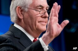 FILE - Secretary of State Rex Tillerson waves goodbye at the State Department in Washington, March 13, 2018, after his firing earlier in the day. President Donald Trump said he would nominate CIA Director Mike Pompeo as the top U.S. diplomat.