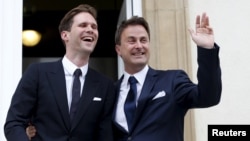 Luxembourg's Prime Minister Xavier Bettel waves as he poses with his partner, Belgian Gauthier Destenay, after their wedding ceremony at Luxembourg's city hall, May 15, 2015. 