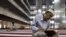 FILE - A man reads the Koran at Istiqlal mosque in Jakarta, July 24, 2012. 