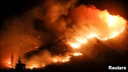 Fire is seen on a hill in Pirque, on the outskirts of Santiago, Chile Jan. 20, 2017.