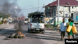 Peacekeepers serving in the United Nations Organization Stabilization Mission in the Democratic Republic of the Congo (MONUSCO) drive past burning tyres as they patrol during protests against President Joseph Kabila in the streets of the Democratic Republ