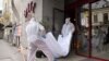 Forensic workers carry the body of Gholamreza Mansouri from a hotel in downtown Bucharest, Romania, June 19, 2020. 