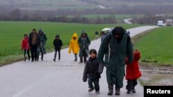 Migrants walk along a road from the village of Chamilo to the migrant camp at the village of Idomeni, near the Greek-Macedonian border, Greece, March 15, 2016.