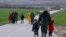 Migrants walk along a road from the village of Chamilo to the migrant camp at the village of Idomeni, near the Greek-Macedonian border, Greece, March 15, 2016.