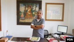 Youk Chhang, director of Documentation Center of Cambodia, stand near donated classified-document from Australian External Foreign Affairs Department, Phnom Penh, Cambodia, September 22, 2015. (NeouVannarin/VOA Khmer)