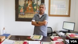 Youk Chhang, director of Documentation Center of Cambodia, stand near the donated classified-document from Australian External (Foreign) Affairs Department on September 22, 2015. (Neou Vannarin/VOA Khmer)