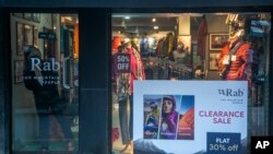 A Nepalese woman waits for customers at a trekking gear store at Thamel, a touristic hub in Kathmandu, Nepal, Monday, Nov. 2, 2020. (AP Photo/Niranjan Shrestha)