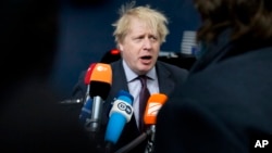 British Foreign Secretary Boris Johnson speaks with the media as he arrives for a meeting of EU foreign ministers at the Europa building in Brussels, March 19, 2018. 