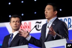 Entrepreneur Andrew Yang, right, speaks next to South Bend, Indiana, Mayor Pete Buttigieg during a Democratic presidential candidates debate at Otterbein University in Westerville, Ohio, Oct. 15, 2019.