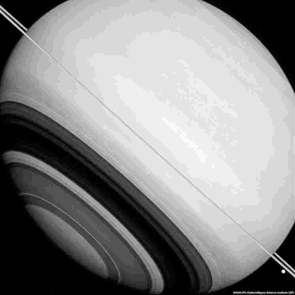 This Aug. 14, 2014 image made available by NASA shows shadows of Saturn&#39;s rings projected on the southern hemisphere of the gas giant.