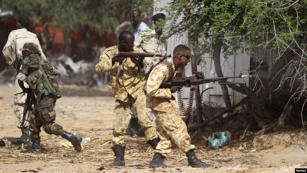 Somali government soldiers open fire during ambush by al-Shabaab rebels on the outskirts of Elasha town, May 29, 2012.