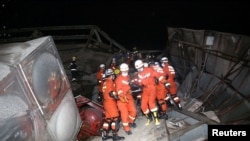 Rescue workers move an injured person on the site where a hotel being used for coronavirus quarantine collapsed, in the southeastern port city of Quanzhou, China March 7, 2020.