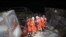 Rescue workers move an injured person on the site where a hotel being used for coronavirus quarantine collapsed, in the southeastern port city of Quanzhou, China March 7, 2020.