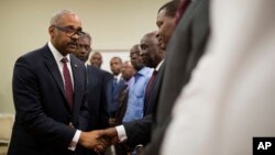 FILE - Haiti's newly nominated Prime Minister Dr. Jack Guy Lafontant greets Senate members after his speech at the national palace during the ceremony of his nomination as new prime minister in Port-au-Prince, Haiti. 