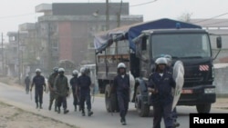 FILE - Cameroonian riot police patrol a street in the port city of Douala, Feb. 25, 2008. Incidents of street justice are growing in Cameroon.