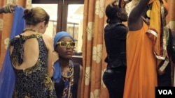 Models wearing East African designer clothing prepare for a runway show in Kampala, Uganda, May 17, 2014. (Hilary Heuler / VOA News)