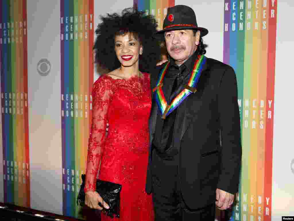 Kennedy Center Honoree Carlos Santana and his wife Cindy Blackman arrive for the Kennedy Center Honors in Washington, Dec. 8, 2013. 