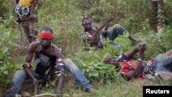 Anti-balaka fighters from the town of Bossembele rest while on patrol in the Boeing district of Bangui, Central African Republic, February 24, 2014.