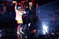 FILE - Lil Wayne and Chance the Rapper perform during halftime of the NBA All-Star basketball game, Feb. 16, 2020, in Chicago.