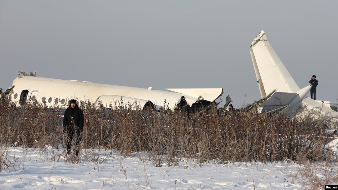 Emergency and security personnel are seen at the site of a plane crash near Almaty, Kazakhstan, Dec. 27, 2019. 