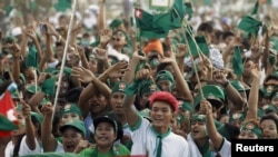 Supporters wave flags during Union Solidarity and Development Party (USDP) campaign rally in Yangon, Nov. 6, 2015.