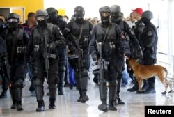 FILE - Members of Brazil's Battalion of Special Operations (BOPE) participate during a crisis simulation exercise to show the media how security will be provided during the 2016 Olympics in Rio de Janeiro, Brazil, Feb. 11, 2015.