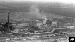 FILE - An aerial view of the Chernobyl nuclear power plant shortly after the 1986 explosion of its smoking fourth reactor. A Russian official is warning that an abandoned chemical plant in Siberia poses an environmental threat that could rival Chernobyl.