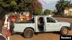 Private security is deployed in front of the parliament building amid heavy gunfire in Guinea Bissau's capital, Bissau, Dec. 1, 2023. 