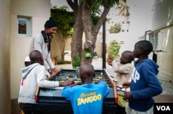 Talibés who were abused by their teachers play with Alassane Diagne, a coordinator at their shelter, Dec. 12, 2019, in Dakar, Senegal. (Annika Hammerschlag/VOA)