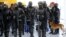 FILE - Members of Brazil's Battalion of Special Operations (BOPE) participate during a crisis simulation exercise conducted by the BOPE to show the media how security will be provided during the 2016 Olympics at the Golf Olympic bus station in Rio de Janeiro, Feb. 11, 2015.