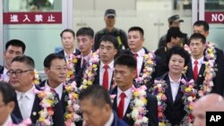 FILE - In this June 23, 2017, file photo, North Korean taekwondo demonstration team members and other officials arrive at Gimpo International Airport in Seoul, South Korea. Many in South Korea, including President Moon Jae-in, hope to use next year's Pyeongchang Olympics as a venue to promote peace with rival North Korea.