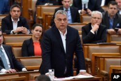 Hungarian Prime Minister Viktor Orban replies during a question-and-answer session of the Parliament in Budapest, Hungary, March 30, 2020.