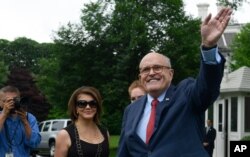 FILE - President Donald Trump's lawyer Rudy Giuliani waves as he attends the White House Sports and Fitness Day event on the South Lawn of the White House in Washington, May 30, 2018.