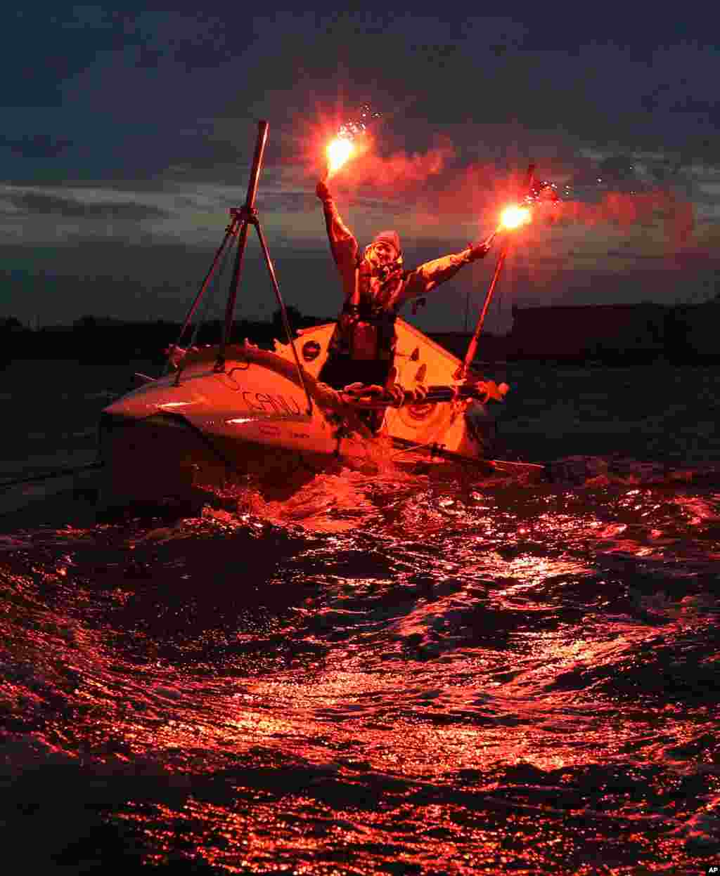 Quebec rower Mylene Paquette celebrates as she arrives in Lorient, western France, after a solo journey across the Atlantic Ocean. Paquette is the first North American woman to row solo across the North Atlantic. She left Halifax just over four months ago in a specially designed 7.3-meter boat propelled only by Paquette and the currents.