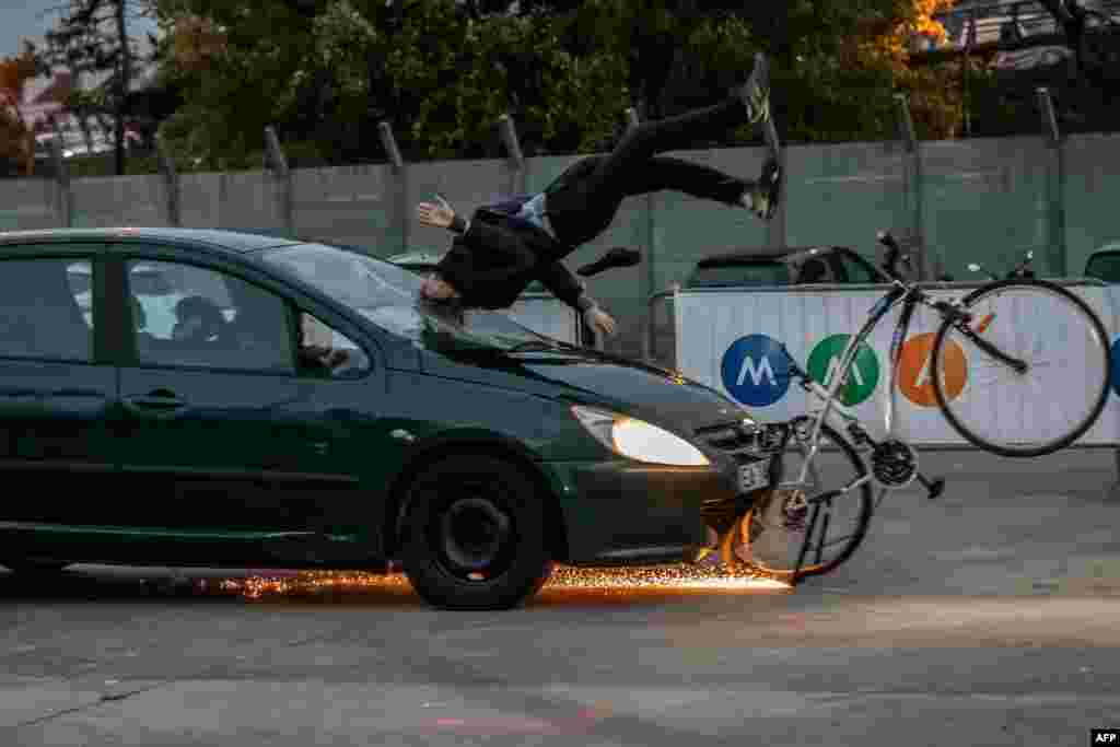 A car collides with a mannequin on an bike during a crash test in Paris.