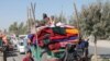 FILE - Afghan families leave their houses after fighting between the Afghan military and Taliban insurgents in Helmand province, Afghanistan, Oct. 13, 2020.